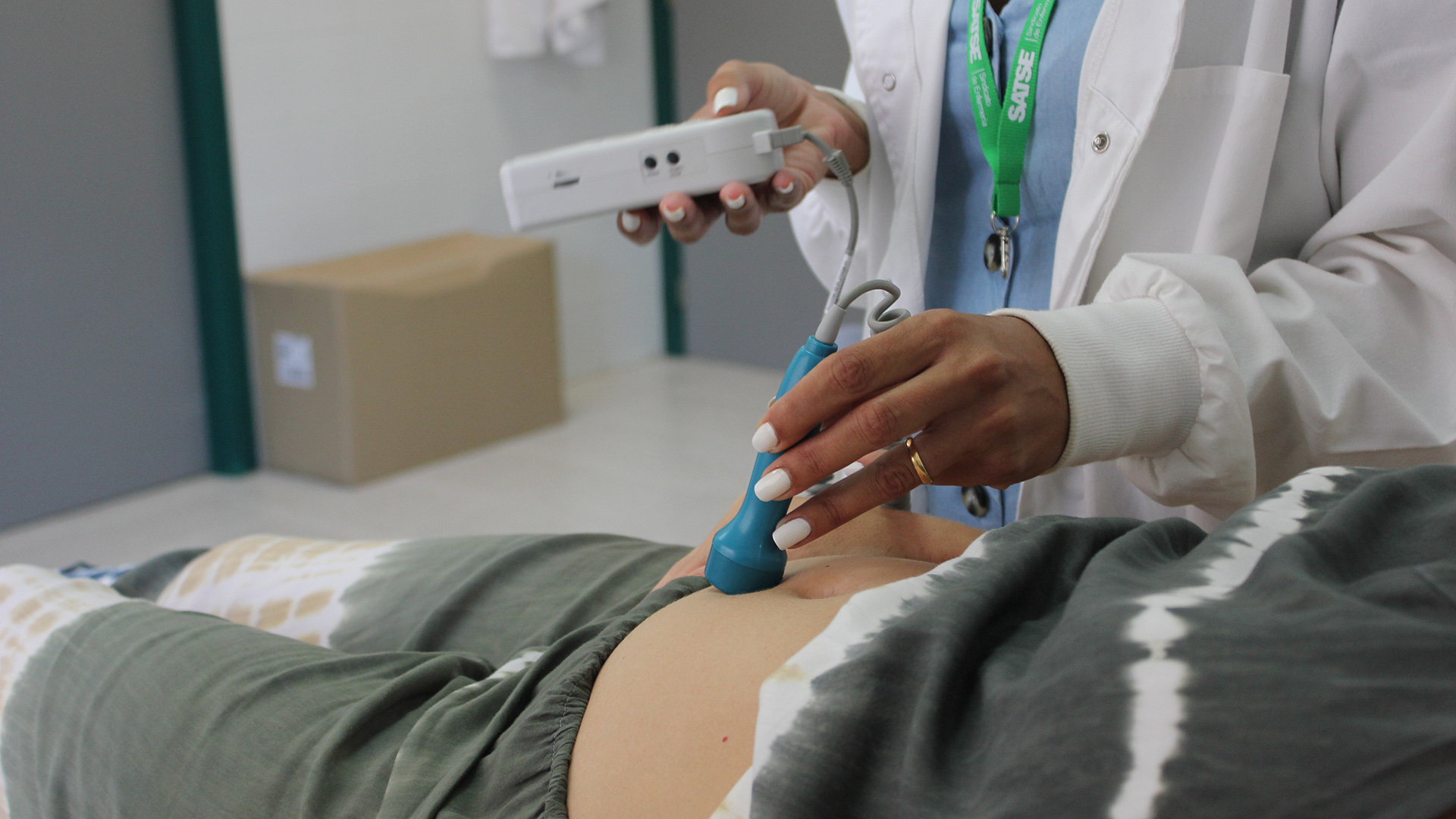 Una matrona una un ecógrafo con una paciente en un centro de salud